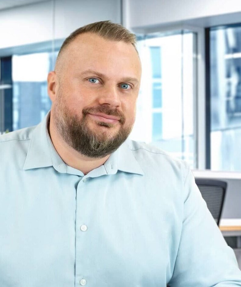 man blue shirt with office background