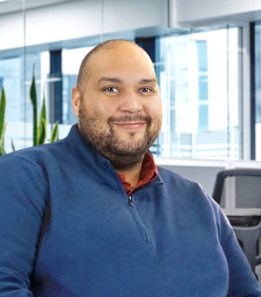 smiling man in blue jumper
